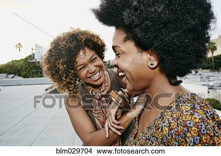 Women laughing on urban rooftop View Large Photo Image Picture - Women laughing on urban rooftop. Fotosearch