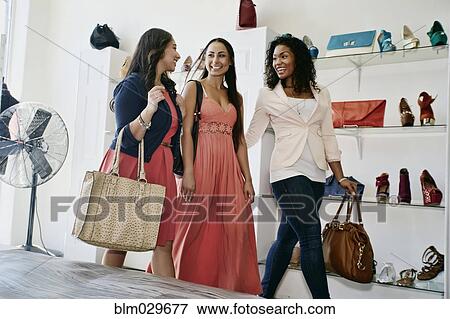 Women shopping together in shoe store View Large Photo Image Stock Photo - Women shopping together in shoe store. Fotosearch