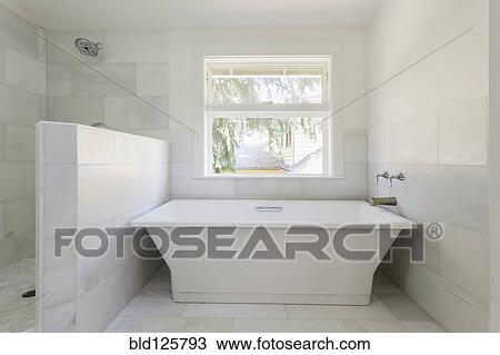 Stock Image - Bathtub and shower in modern bathroom. Fotosearch