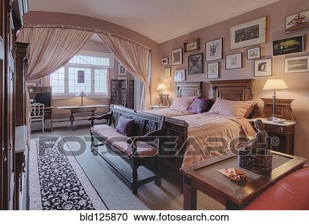 Stock Image - Bed and benches in bedroom. Fotosearch