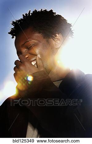 Black man laughing outdoors View Large Photo Image Stock Photo - Black man laughing outdoors. Fotosearch