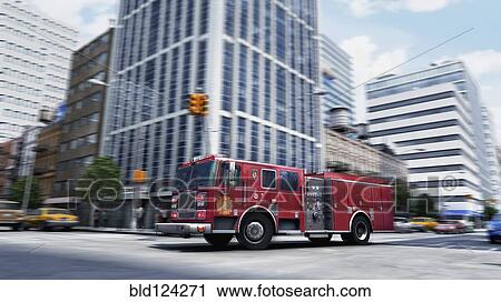 Stock Image - Blurred view of fire truck driving through intersection, New York, New York, United States. Fotosearch