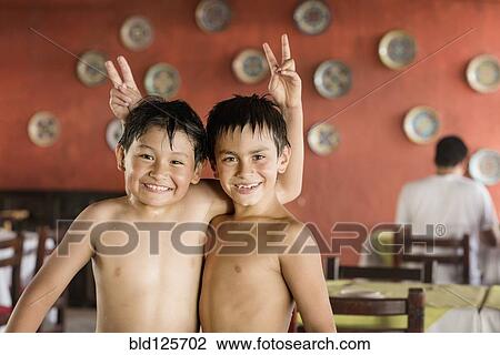 Boys giving each other bunny ears View Large Photo Image Stock Image - Boys giving each other bunny ears. Fotosearch