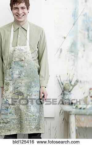Stock Photograph - Caucasian artist smiling in studio. Fotosearch