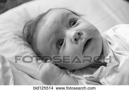 Picture - Caucasian baby boy laying on blanket. Fotosearch