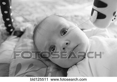Stock Image - Caucasian baby boy laying on blanket. Fotosearch