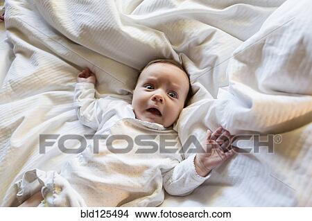 Caucasian baby gasping in bed View Large Photo Image Picture - Caucasian baby gasping in bed. Fotosearch