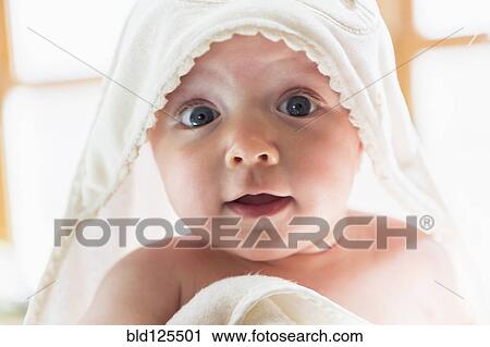 Stock Image - Caucasian baby wrapped in towel. Fotosearch