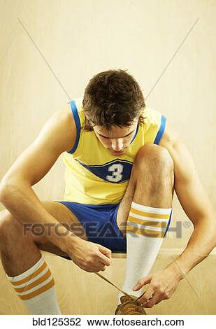 Caucasian basketball player tying shoes View Large Photo Image Stock Image - Caucasian basketball player tying shoes. Fotosearch