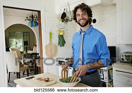 Caucasian businessman cooking in kitchen View Large Photo Image Stock Photograph - Caucasian businessman cooking in kitchen. Fotosearch