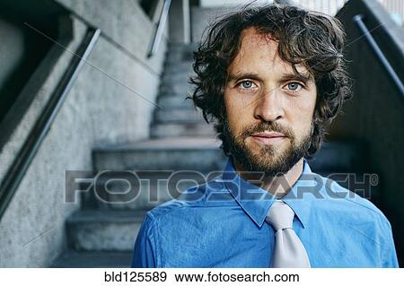 Stock Photo - Caucasian businessman standing outdoors. Fotosearch