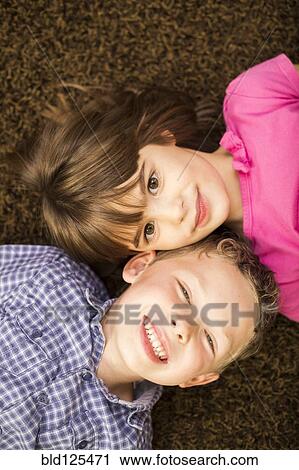 Caucasian children laying on carpet View Large Photo Image Stock Image - Caucasian children laying on carpet. Fotosearch
