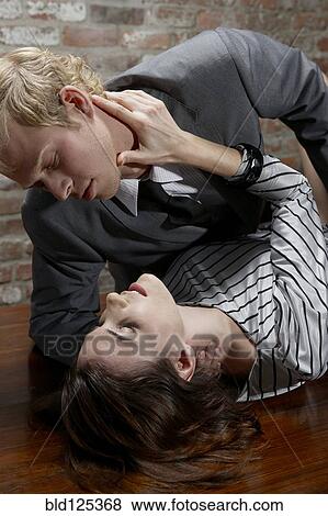 Stock Photo - Caucasian couple embracing seductively on table. Fotosearch