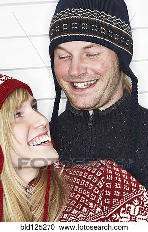 Stock Image - Caucasian couple wearing winter hats. Fotosearch
