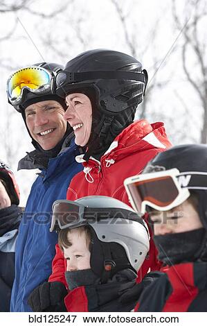 Caucasian family wearing ski gear in snow View Large Photo Image Stock Photo - Caucasian family wearing ski gear in snow. Fotosearch