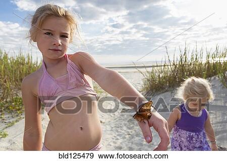 Caucasian girl holding butterfly on beach View Large Photo Image Stock Photo - Caucasian girl holding butterfly on beach. Fotosearch