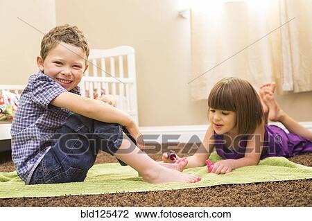 Caucasian girl painting brother's toes View Large Photo Image Stock Image - Caucasian girl painting brother's toes. Fotosearch