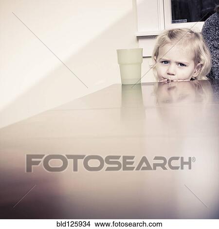 Caucasian girl peering over table View Large Photo Image Picture - Caucasian girl peering over table. Fotosearch