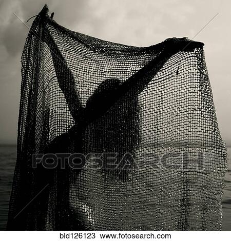 Caucasian girl playing with net on beach View Large Photo Image Stock Image - Caucasian girl playing with net on beach. Fotosearch