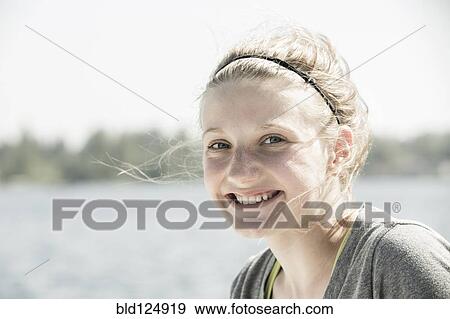 Stock Photo - Caucasian girl smiling outdoors. Fotosearch
