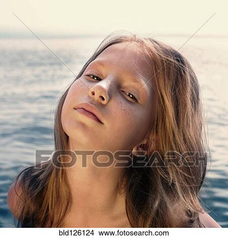 Caucasian girl standing on beach View Large Photo Image Picture - Caucasian girl standing on beach. Fotosearch