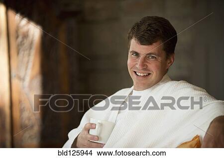 Picture - Caucasian man drinking coffee in bathrobe. Fotosearch