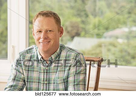 Caucasian man smiling indoors View Large Photo Image Stock Photo - Caucasian man smiling indoors. Fotosearch