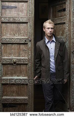 Caucasian man standing in ornate doorway View Large Photo Image Stock Photo - Caucasian man standing in ornate doorway. Fotosearch