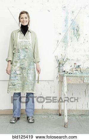 Stock Photo - Caucasian painter smiling in studio. Fotosearch