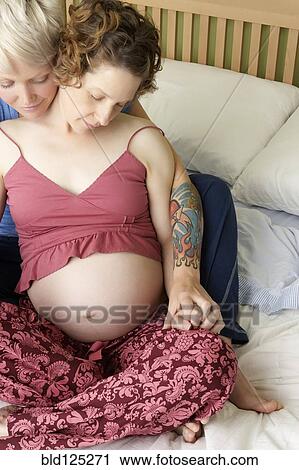 Caucasian pregnant lesbian couple relaxing on bed View Large Photo Image Stock Image - Caucasian pregnant lesbian couple relaxing on bed. Fotosearch