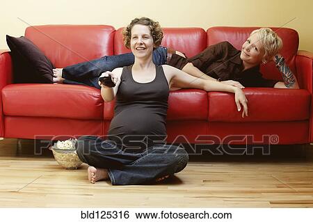 Caucasian pregnant lesbian couple watching TV View Large Photo Image Stock Photograph - Caucasian pregnant lesbian couple watching TV. Fotosearch