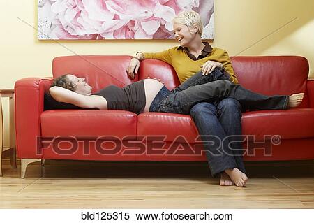 Caucasian pregnant lesbian couple relaxing on sofa View Large Photo Image Stock Photography - Caucasian pregnant lesbian couple relaxing on sofa. Fotosearch