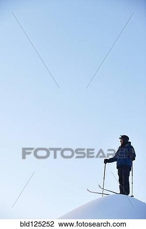 Caucasian skier on hilltop View Large Photo Image Stock Image - Caucasian skier on hilltop. Fotosearch