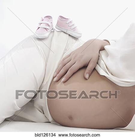 Picture - Caucasian woman holding pregnant belly. Fotosearch