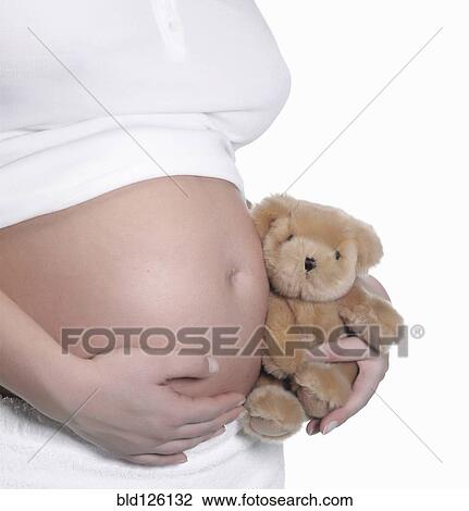 Caucasian woman holding teddy bear to pregnant belly View Large Photo Image Stock Image - Caucasian woman holding teddy bear to pregnant belly. Fotosearch