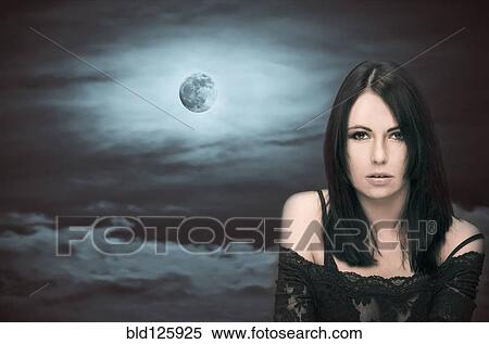 Stock Photography - Caucasian woman in front of full moon. Fotosearch