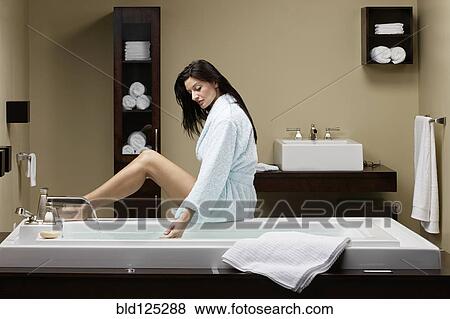 Caucasian woman running bath View Large Photo Image Stock Photo - Caucasian woman running bath. Fotosearch
