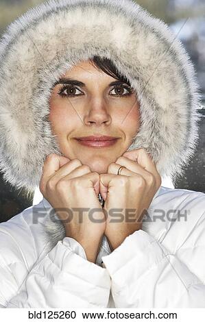 Stock Image - Caucasian woman wearing fur hood. Fotosearch
