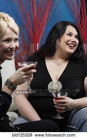 Caucasian women having cocktails together in lounge View Large Photo Image Stock Photo - Caucasian women having cocktails together in lounge. Fotosearch