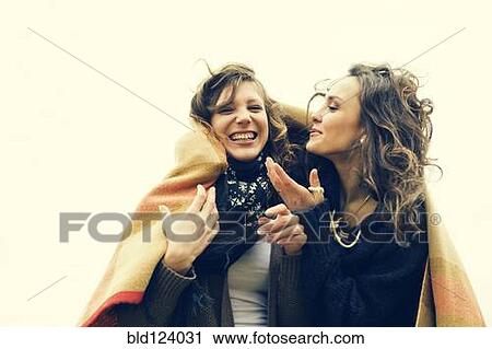 Stock Image - Caucasian women wrapped in a blanket. Fotosearch