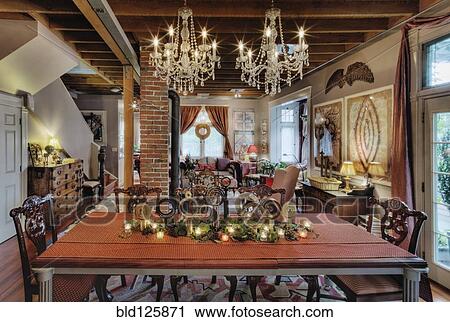 Stock Image - Chandeliers over dining room table. Fotosearch