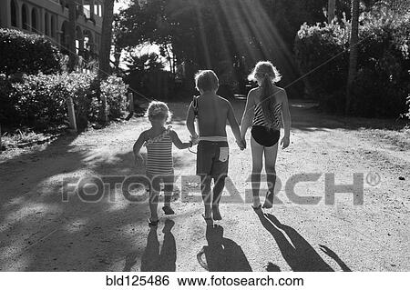 Children in swimsuits holding hands outdoors View Large Photo Image Stock Photograph - Children in swimsuits holding hands outdoors. Fotosearch