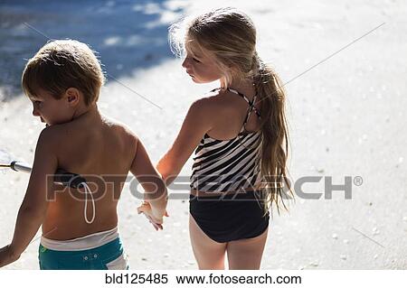 Children in swimsuits holding hands outdoors View Large Photo Image Stock Photography - Children in swimsuits holding hands outdoors. Fotosearch