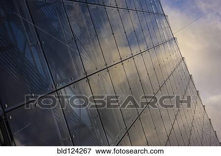Stock Photo - Close up of clouds reflected in windows of highrise. Fotosearch