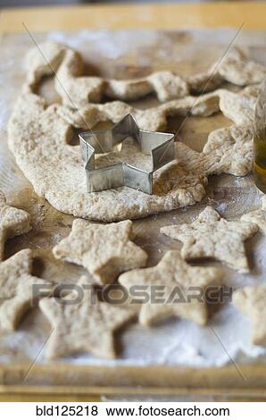 Stock Photo - Close up of cookie cutter and dough. Fotosearch
