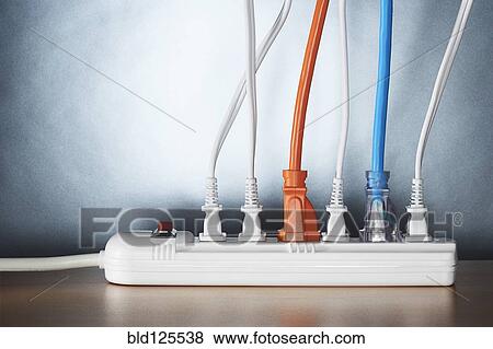 Stock Photo - Close up of cords plugged into power strip. Fotosearch