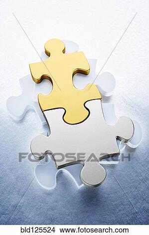 Close up of gold and silver puzzle pieces View Large Photo Image Picture - Close up of gold and silver puzzle pieces. Fotosearch