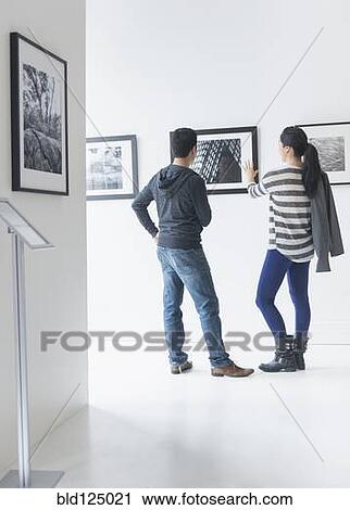 Couple admiring art in gallery View Large Photo Image Stock Image - Couple admiring art in gallery. Fotosearch