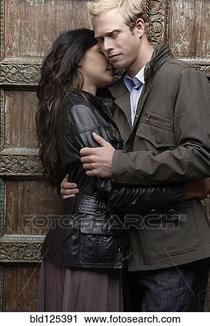 Couple hugging at ornate door View Large Photo Image Stock Image - Couple hugging at ornate door. Fotosearch
