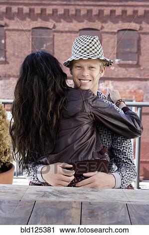 Stock Image - Couple hugging outdoors. Fotosearch